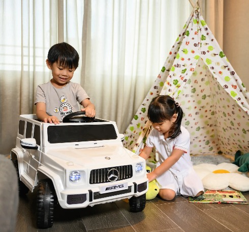 Kids playing with toys in a Dao by Dorsett bedroom.