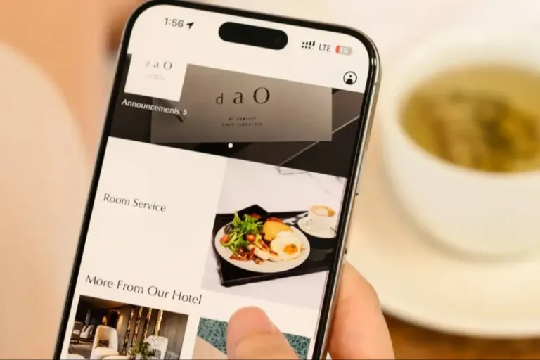 Person scrolling a phone and having a cup of tea cup.