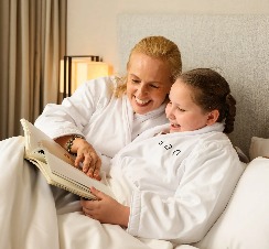 A mother and daughter reading a magazine at Dorsett AMTD Singapore.