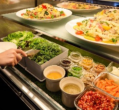 A person serving a meal at the Collective in Dorsett AMTD Singapore.