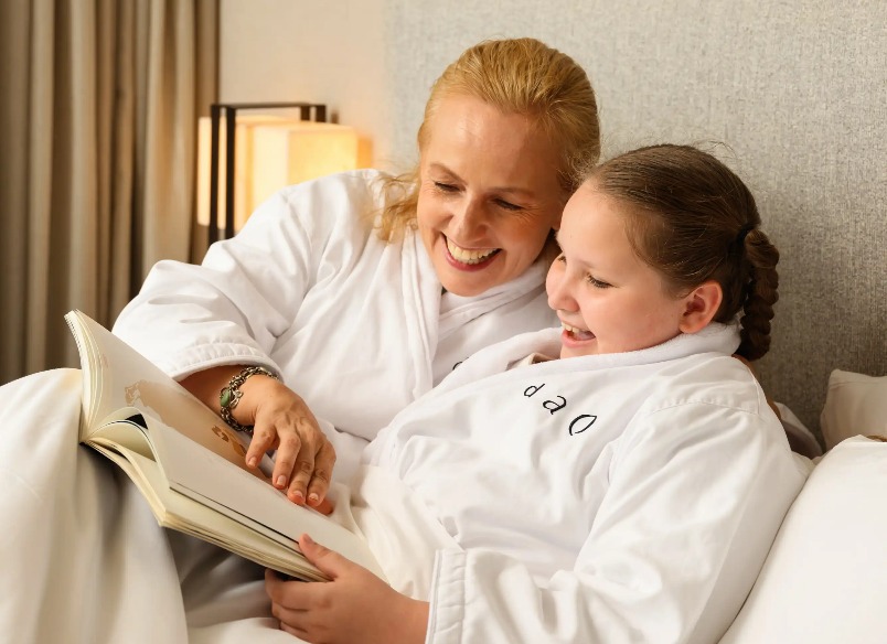 A mother and daughter reading a magazine at Dorsett AMTD Singapore.