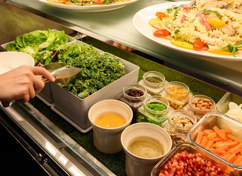 A person serving a meal at the Collective in Dorsett AMTD Singapore.