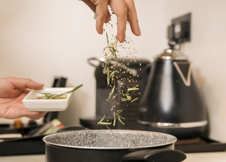 Person cooking in Dao by Dorsett AMTD Singapore room kitchenette