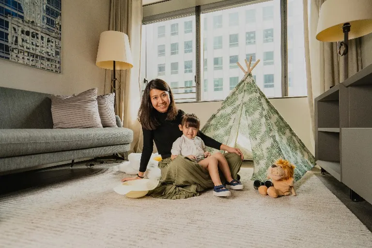 Woman and her child beside a playhouse in a Dao by Dorsett Hotel room.