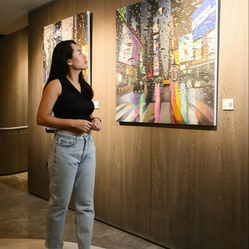 Woman looking at wall art in Dao by Dorsett Hotel.