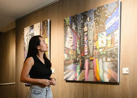 Woman looking at wall art in Dao by Dorsett Hotel.