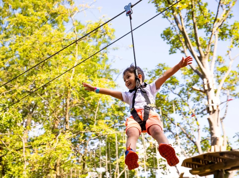 A kid enjoying a zipline ride in Crouch End.