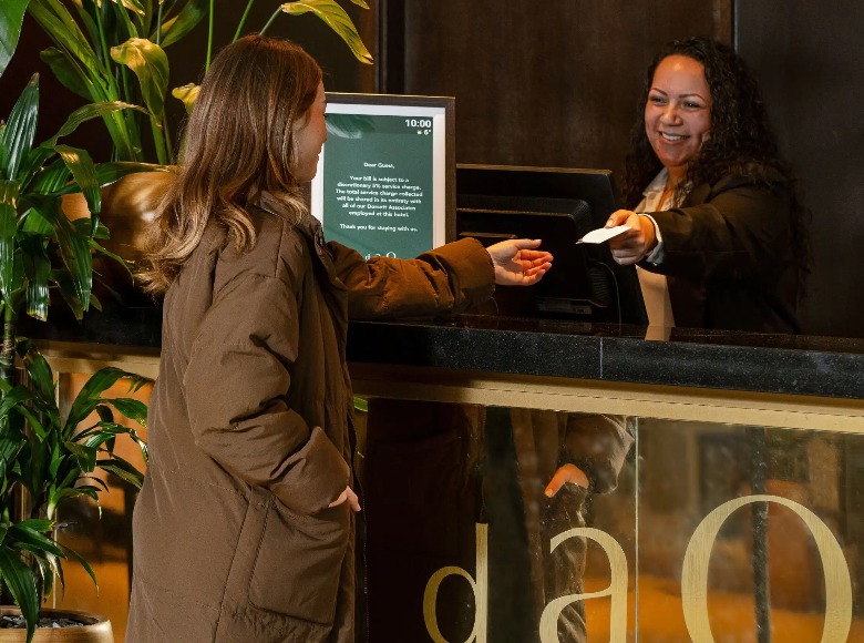 A guest receiving a token at Dao by Dorsett North London.