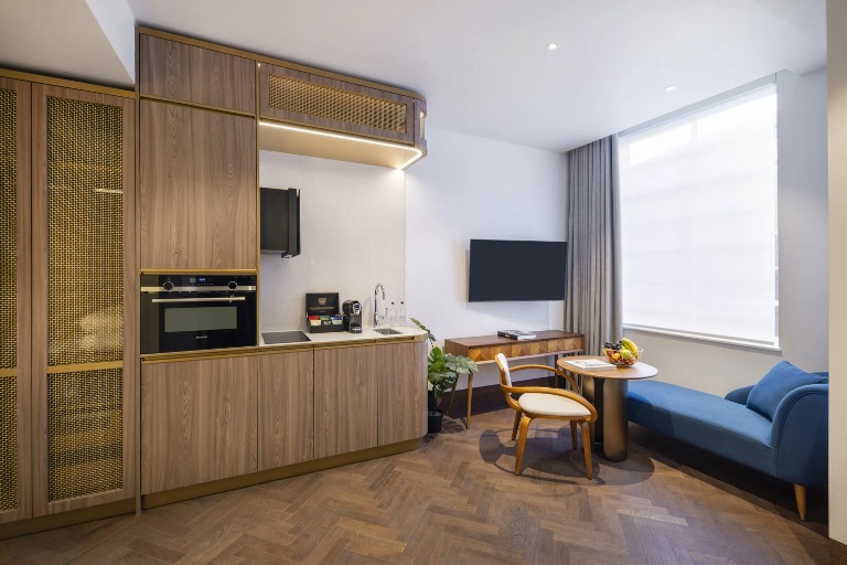 A kitchenette, TV and a table in the Dao Studio, North London.