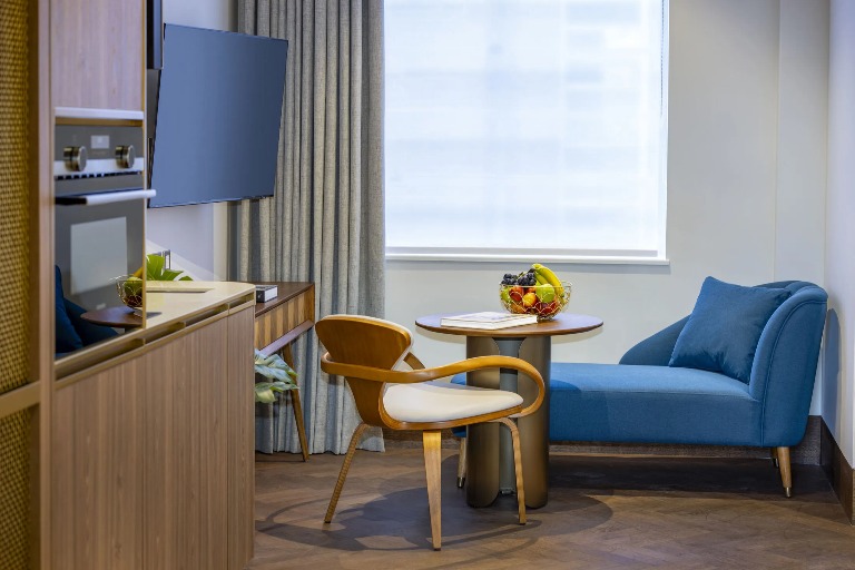 Kitchenettem, settee and a TV in Dao by Dorsett North London Hotel room.