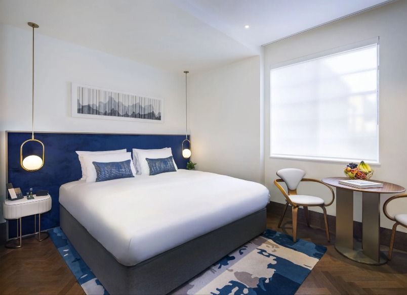 Bed, lamps and a settee in the Dao Studio, North London.