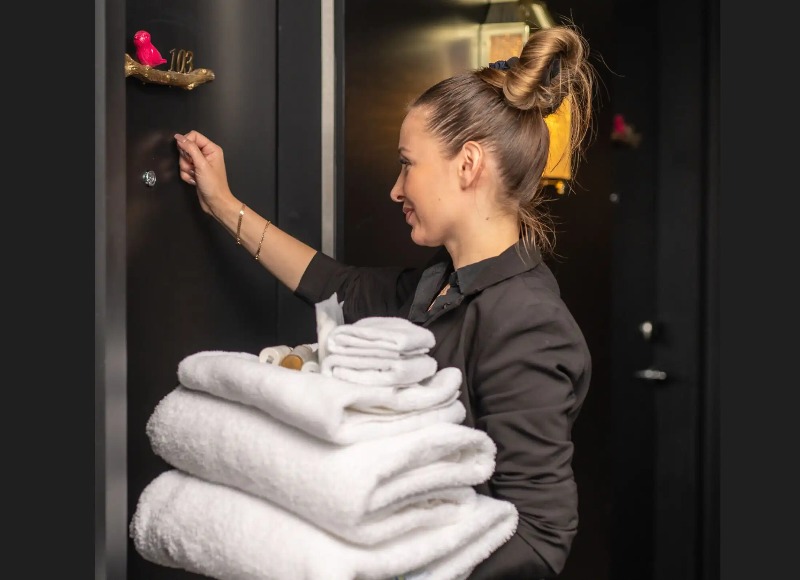 A woman delivering guest amenities at Dao by Dorsett North London.