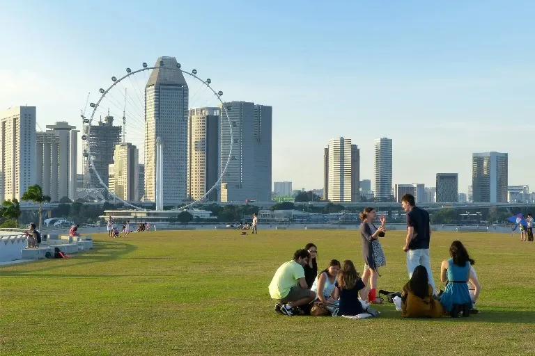 People at the Marina Bay Sands Singapore in front of the waterfront.