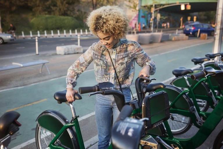 A woman parking her bicycle