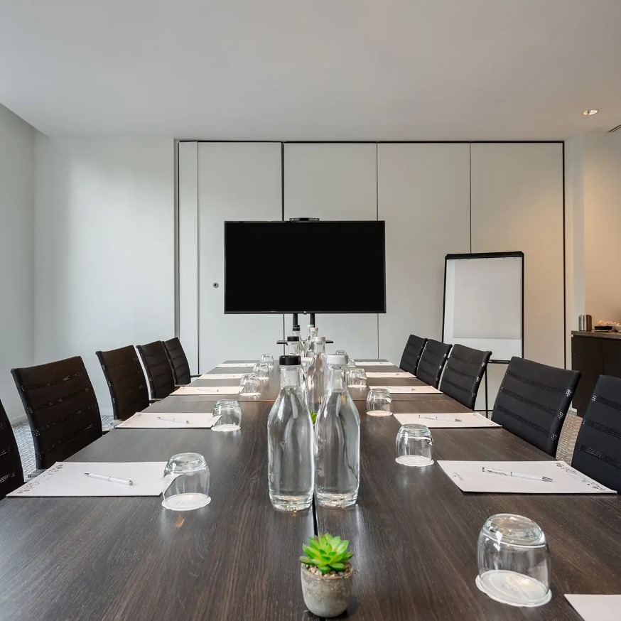 Conference table for 12 and a TV  in the Heron Suite, West London.